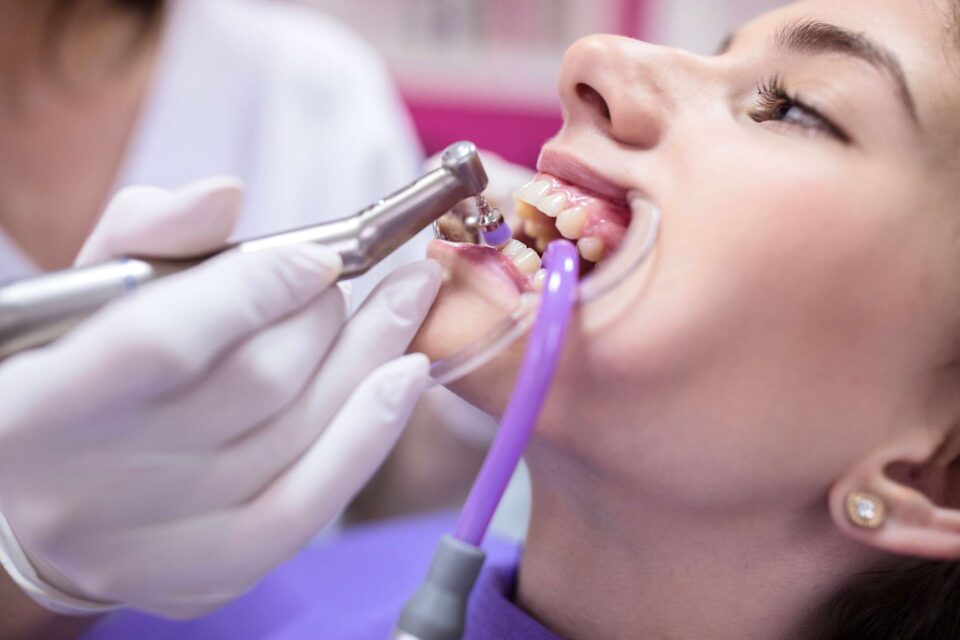 Teeth cleaning at Dental Care of Wheaton in Wheaton, IL, using advanced dental tools.