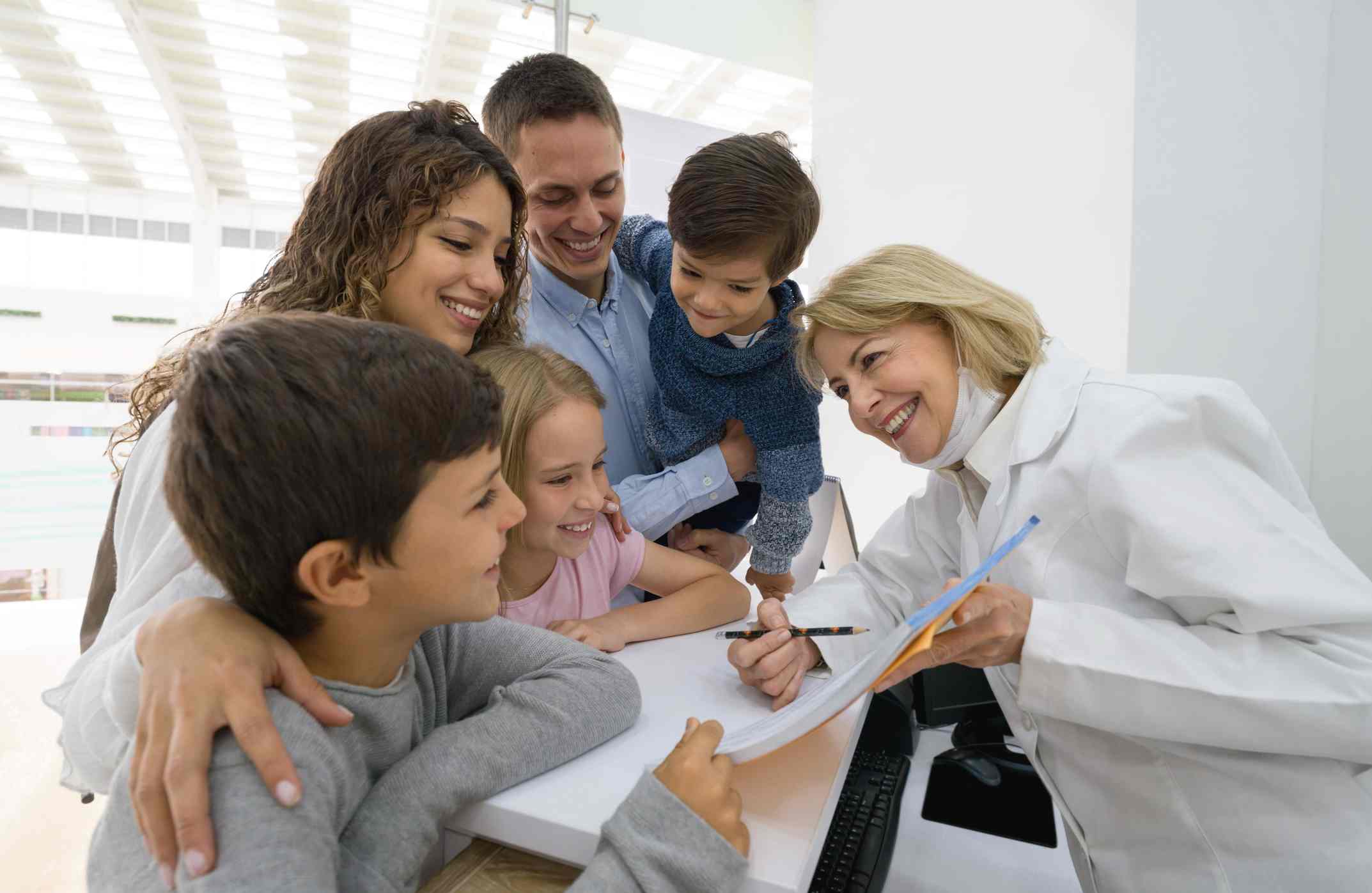 Family consulting with the dentist about care options at the Dental Care of Wheaton office.