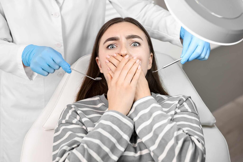 Person in dental chair avoiding treatment showing risks of skipping dental visits in Wheaton, IL