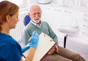 A dentist explaining to a patient the connection between gum disease & diabetes in Wheaton, IL