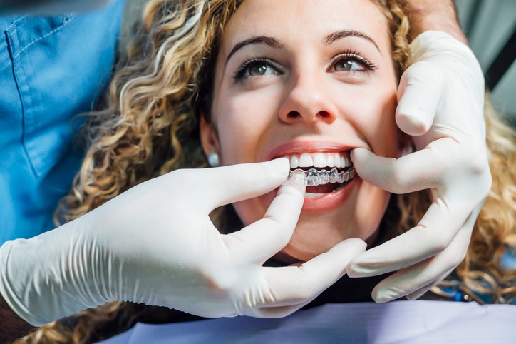 A teen wearing clear aligners during an orthodontic checkup appointment in Wheaton, IL