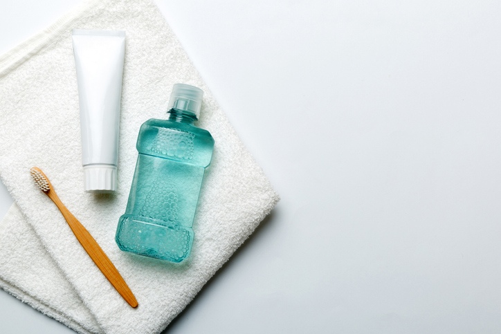 Mouthwash, toothpaste, and toothbrushes are arranged for a daily oral care routine in Wheaton, IL